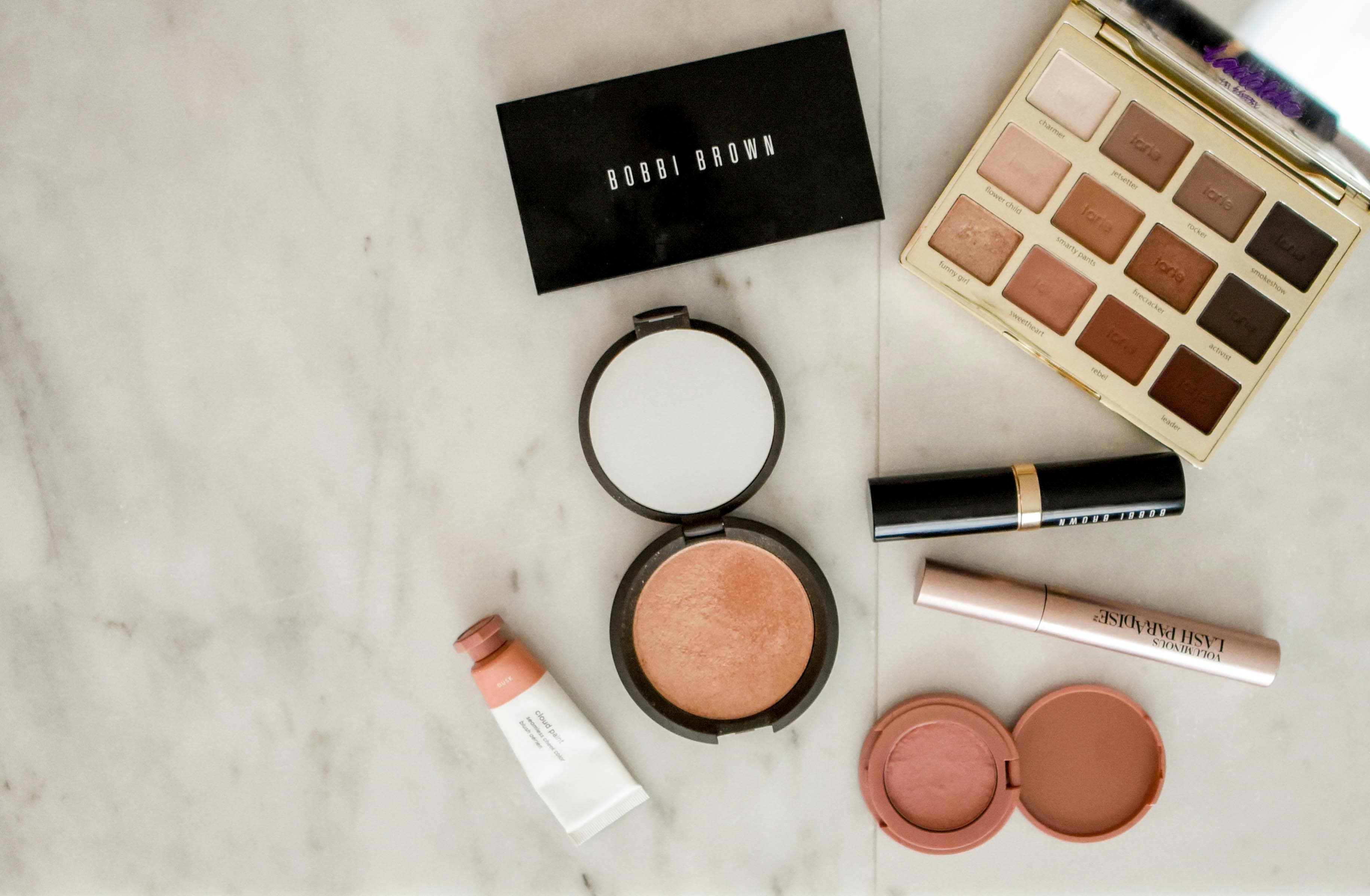 Premium beauty products arranged on a soft neutral backdrop